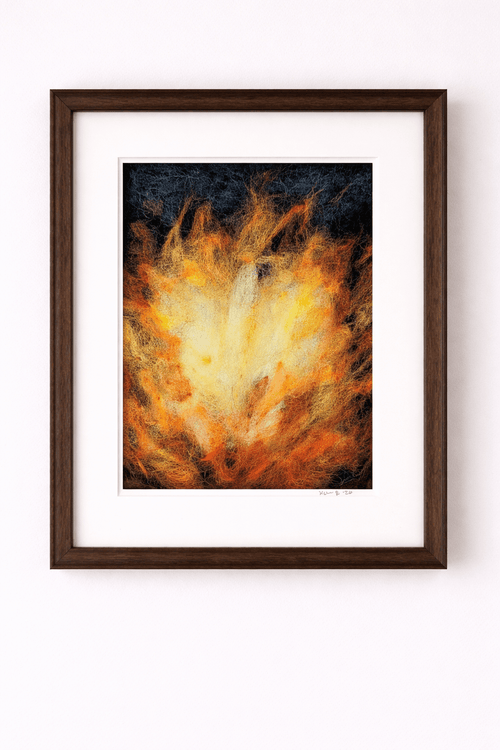 Framed abstract art with fiery design on a white wall